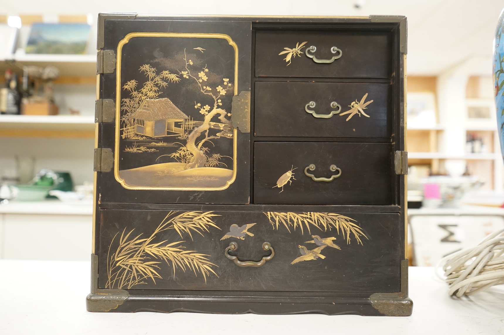 A Chinese export lacquered table cabinet with fitted interior, lacking door, 32cm high